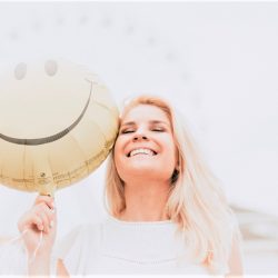 smiling woman with happy face balloon